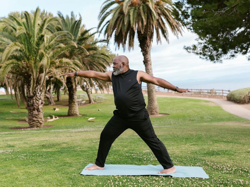 Person doing a balanced arm stand on a mat